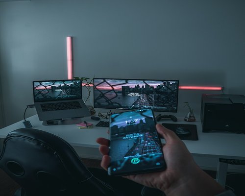 Smartphone displaying a fictional mobile game at an Australian gaming technology exhibition